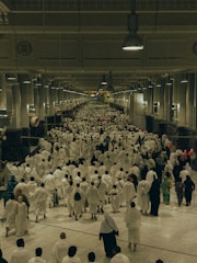 A large group of people walking down a hallway