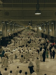 A large group of people walking down a hallway