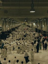A large group of people walking down a hallway