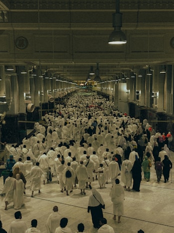 A large group of people walking down a hallway