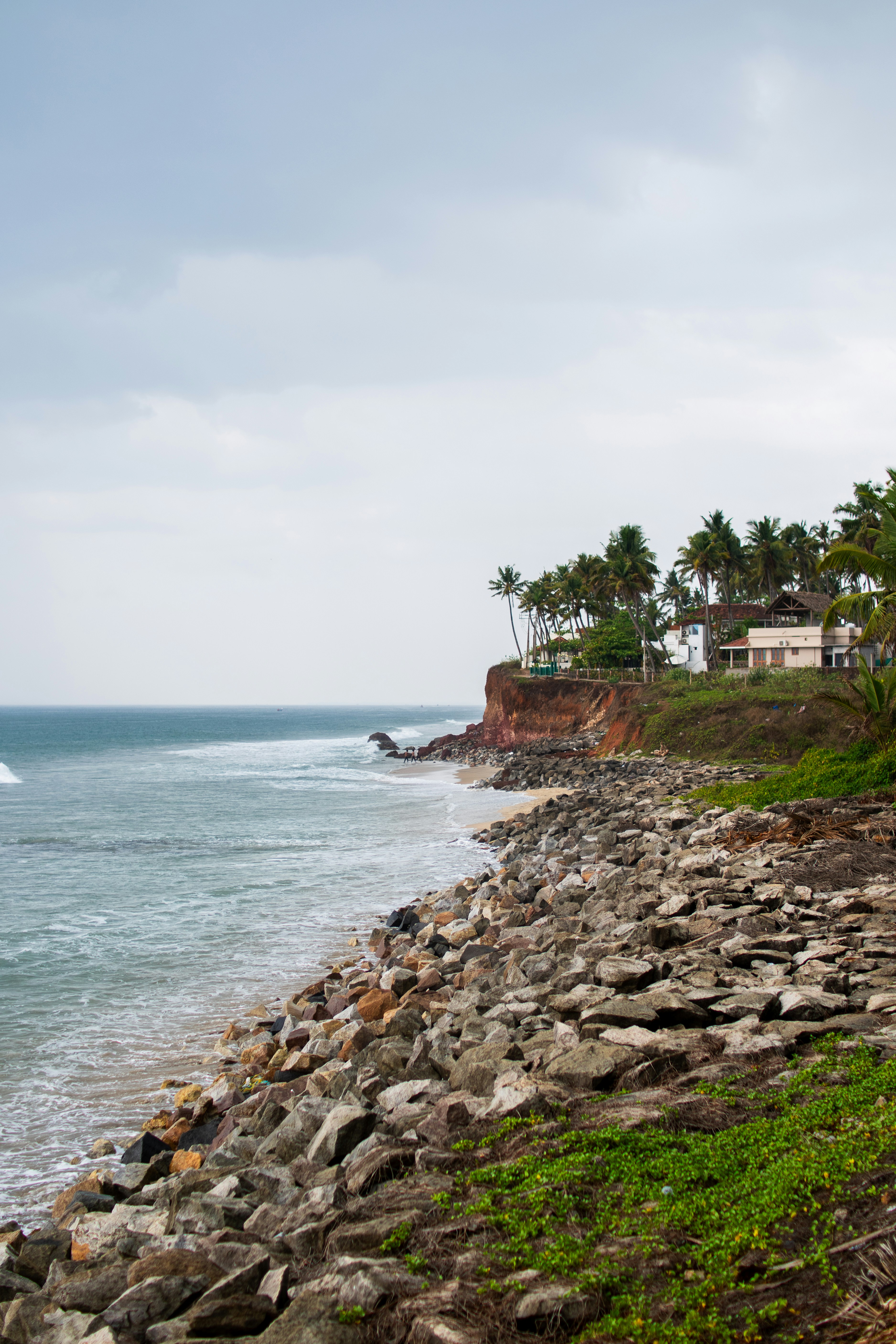 A view of a beach with a house on the shore