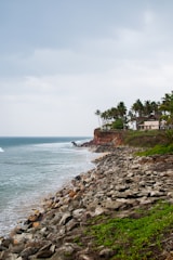 A view of a beach with a house on the shore