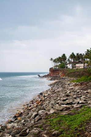A view of a beach with a house on the shore