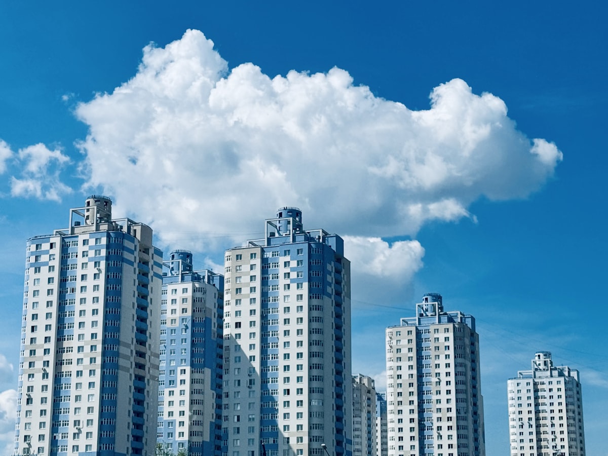 A group of tall buildings next to a body of water