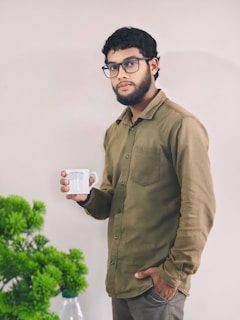 A man holding a coffee cup in his right hand