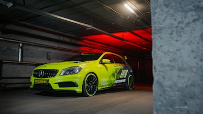 A yellow car parked in a parking garage