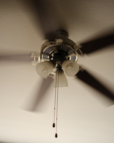 A ceiling fan that is hanging from a ceiling