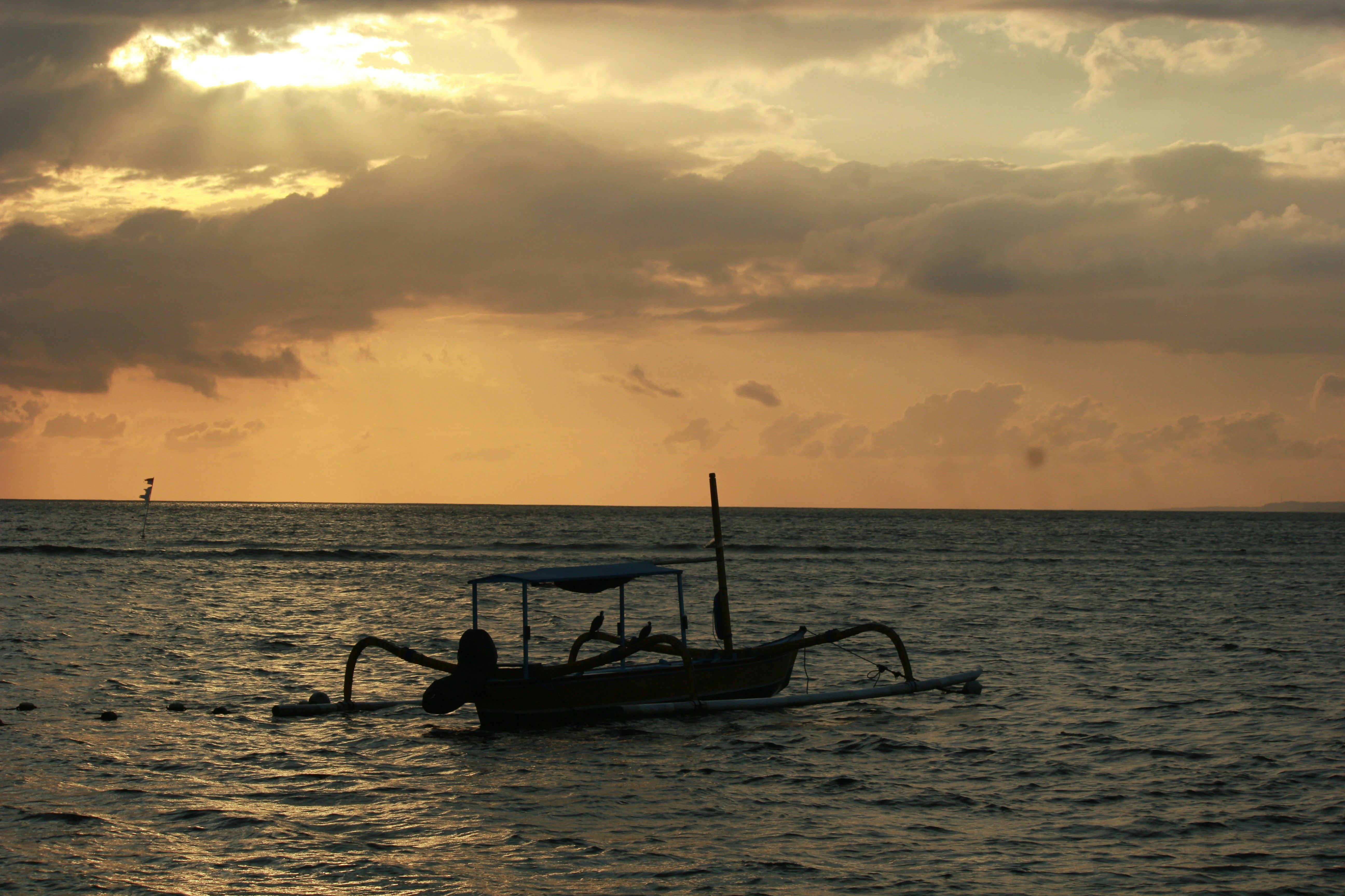 A boat floating on top of a large body of water