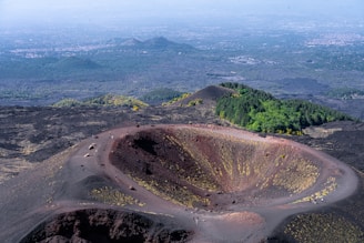 An aerial view of a crater in the middle of a mountain
