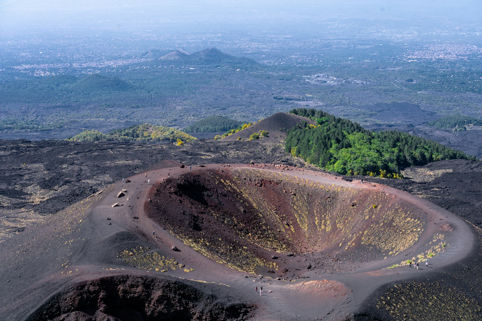 One of the Silvestri craters on Mount Etna's southern slope, a ring of dark volcanic cinder