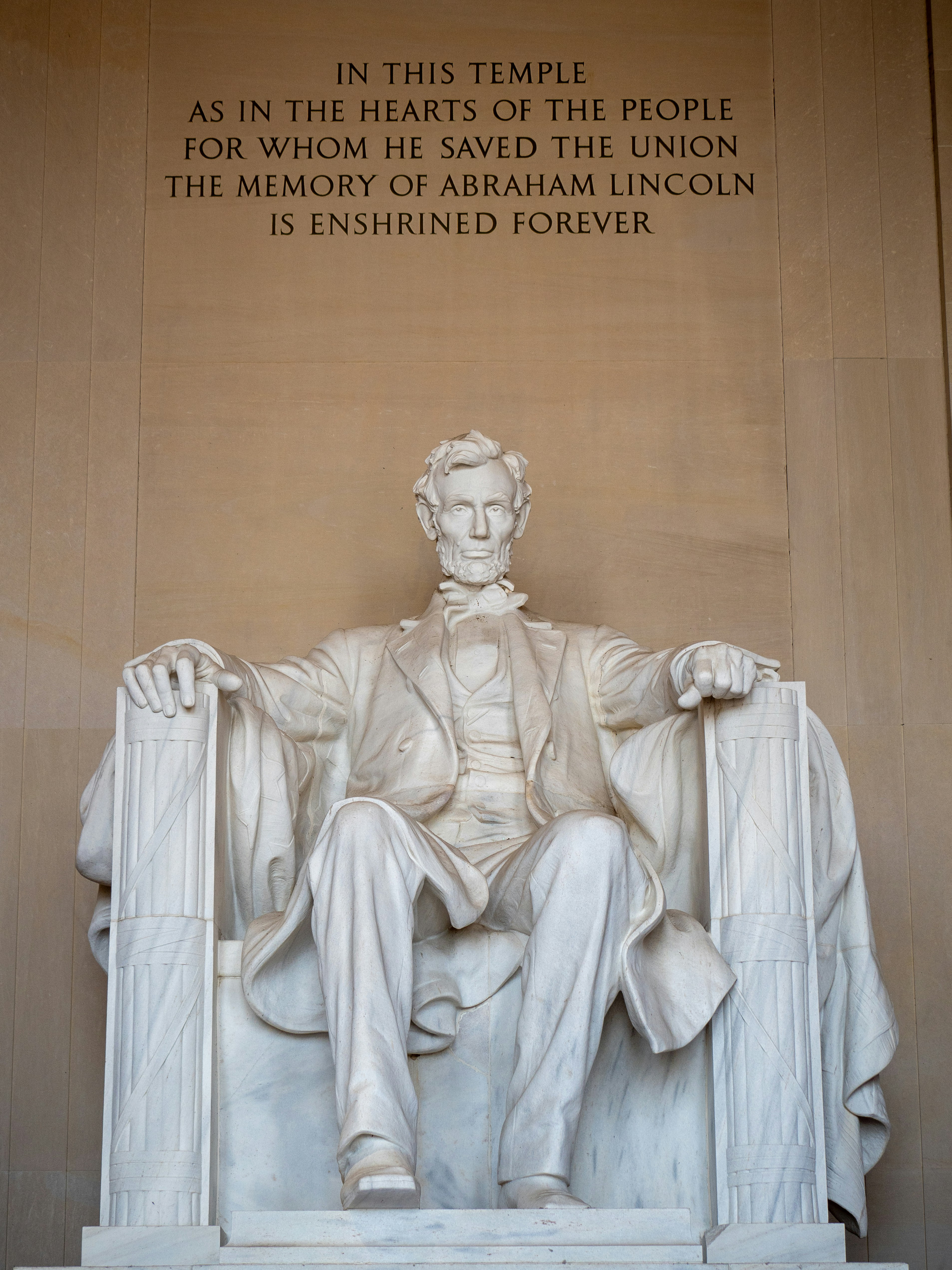 A statue of abraham lincoln in front of the lincoln memorial