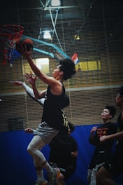 A group of young men playing a game of basketball