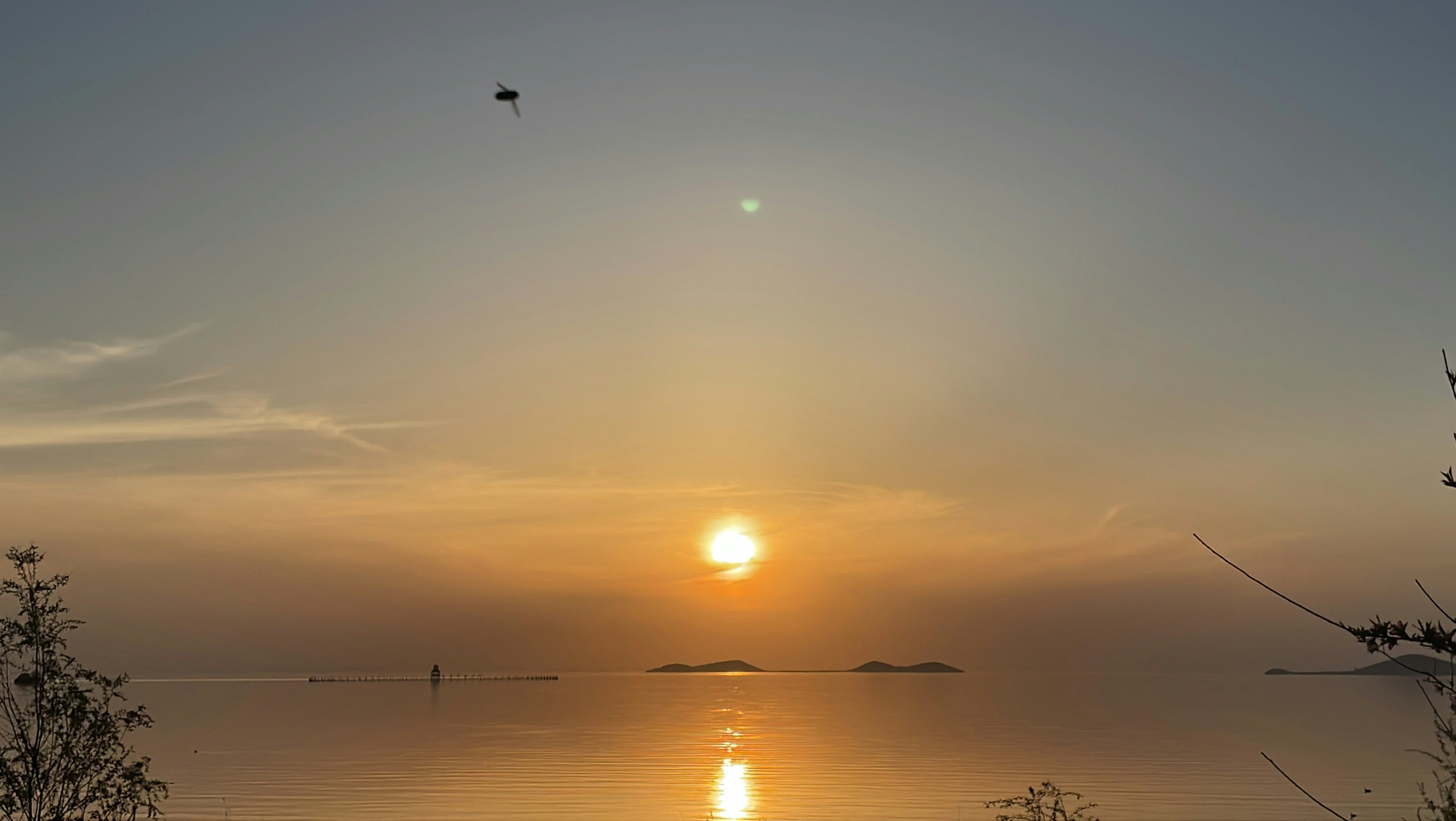 The sun is setting over a body of water