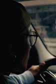 A woman driving a car while holding the steering wheel
