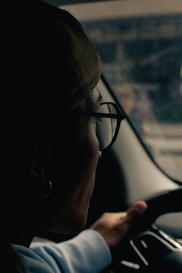 A woman driving a car while holding the steering wheel