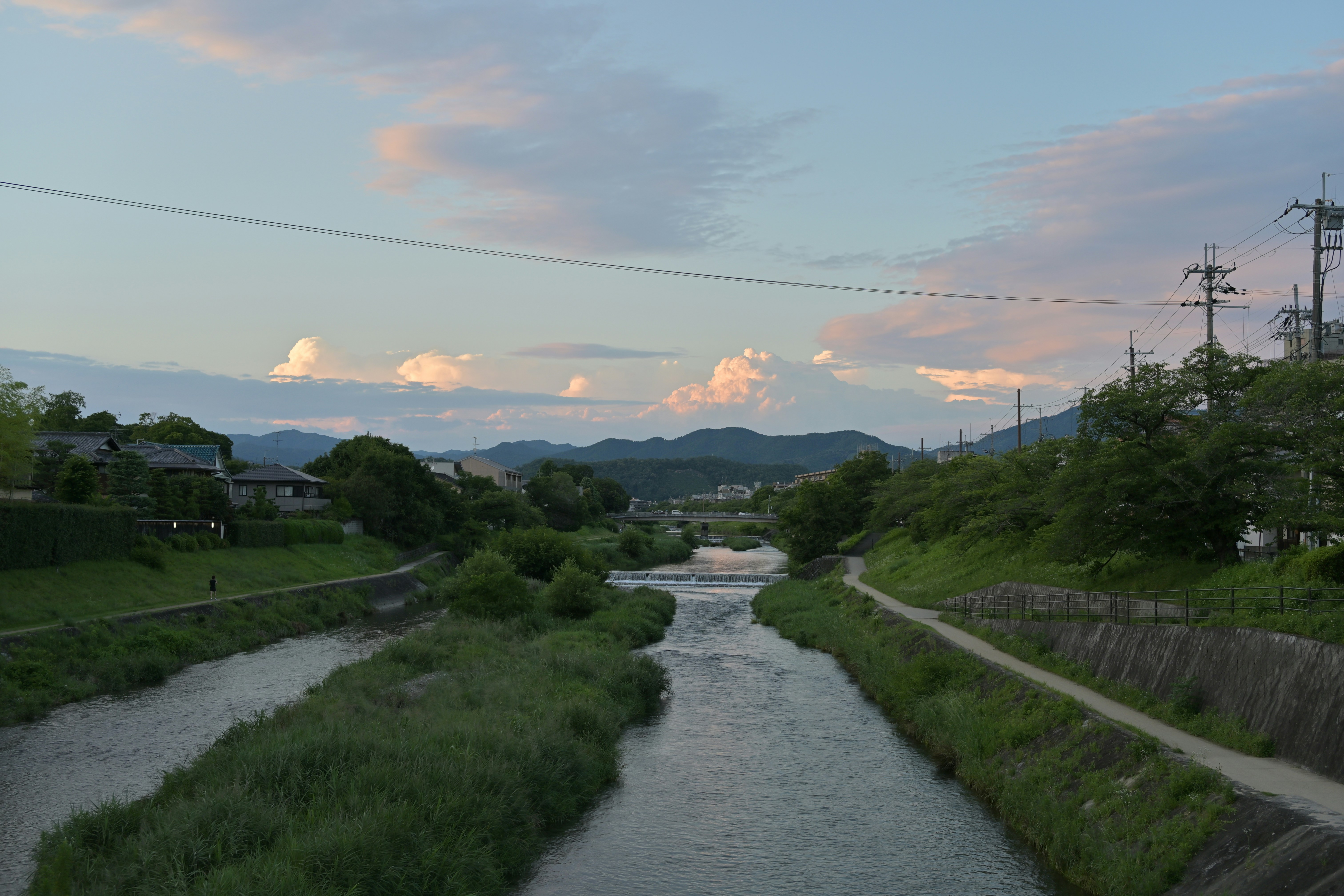 A river running through a lush green countryside