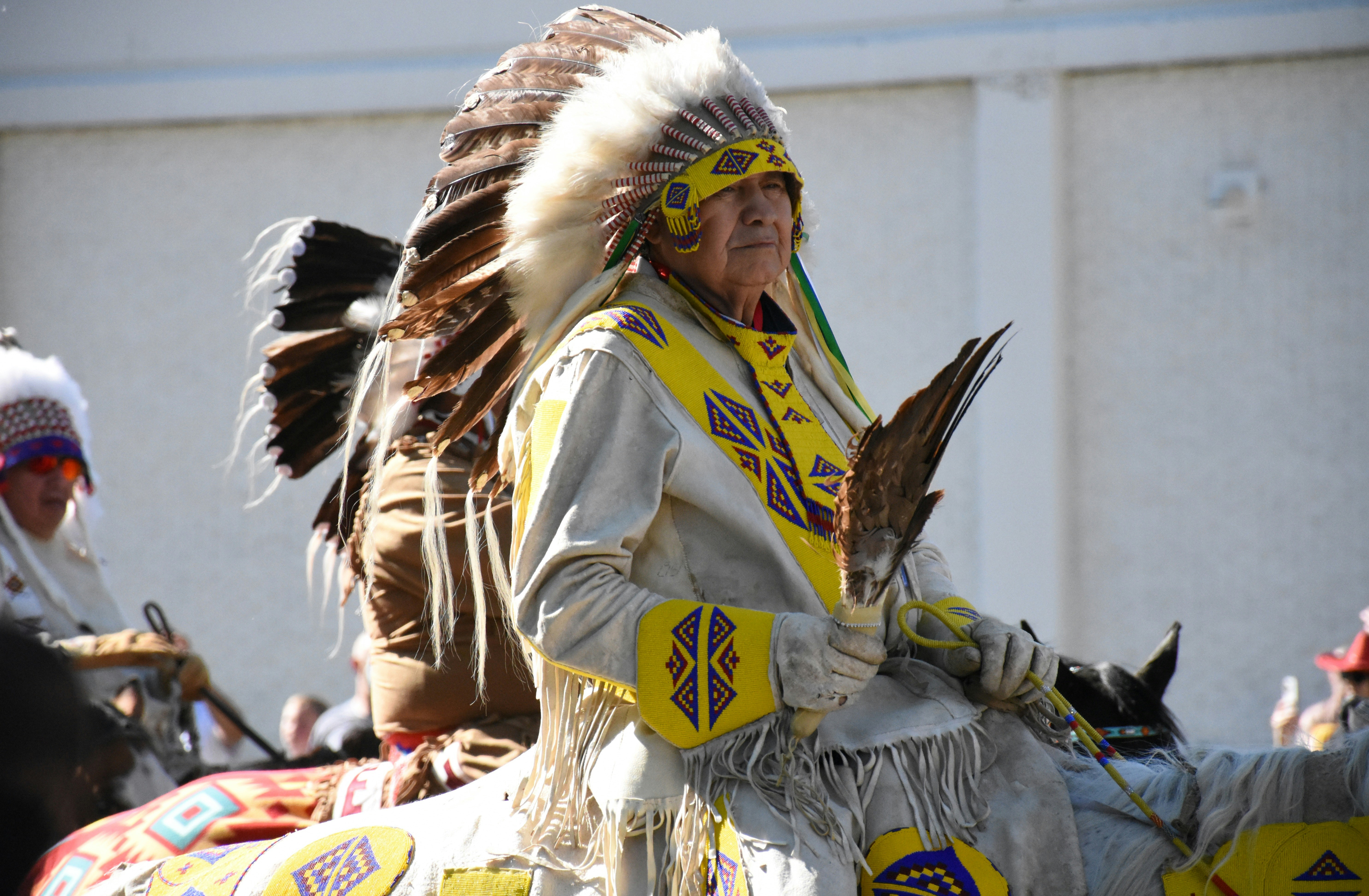 A native american man riding on the back of a horse