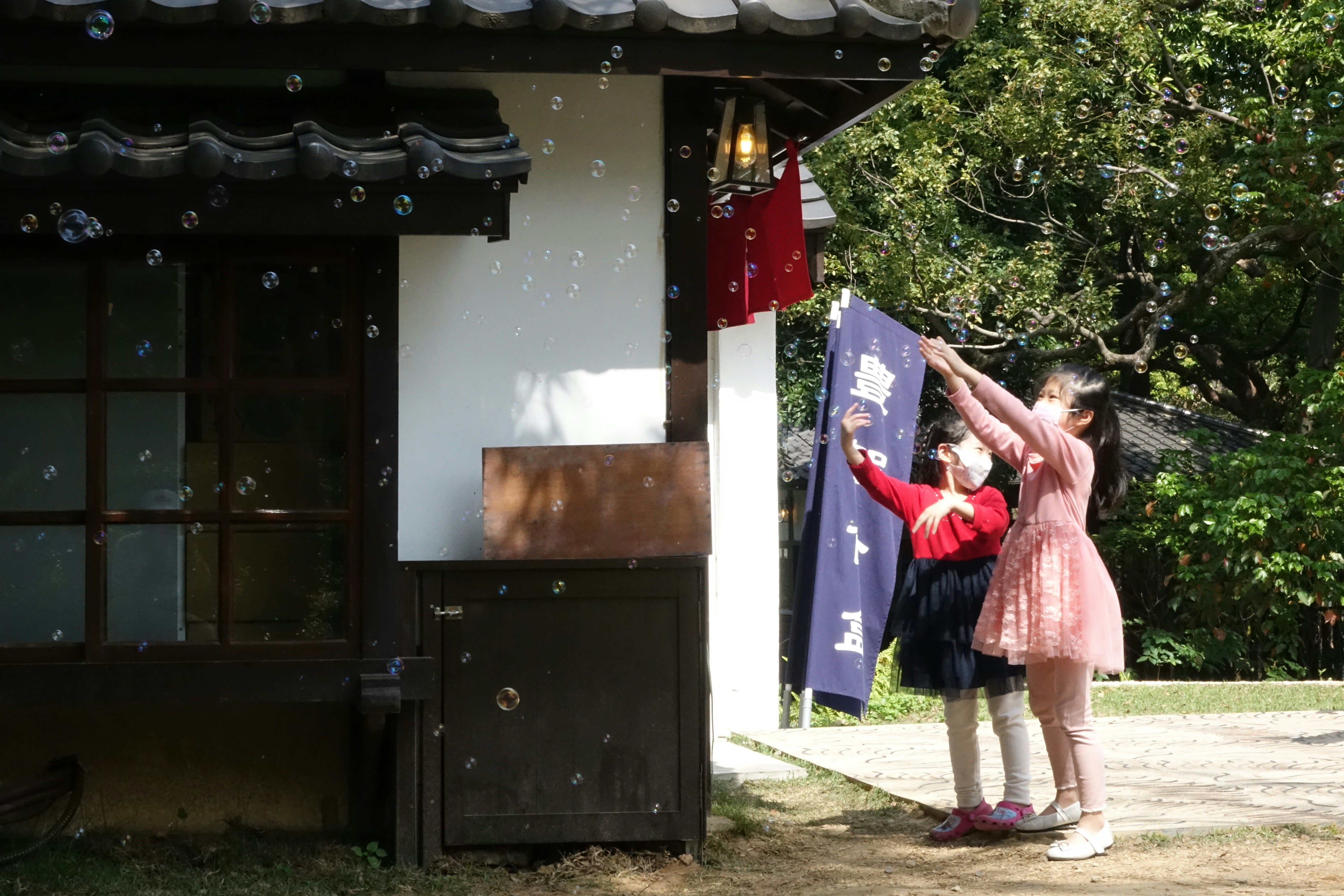 A couple of people that are standing in front of a building