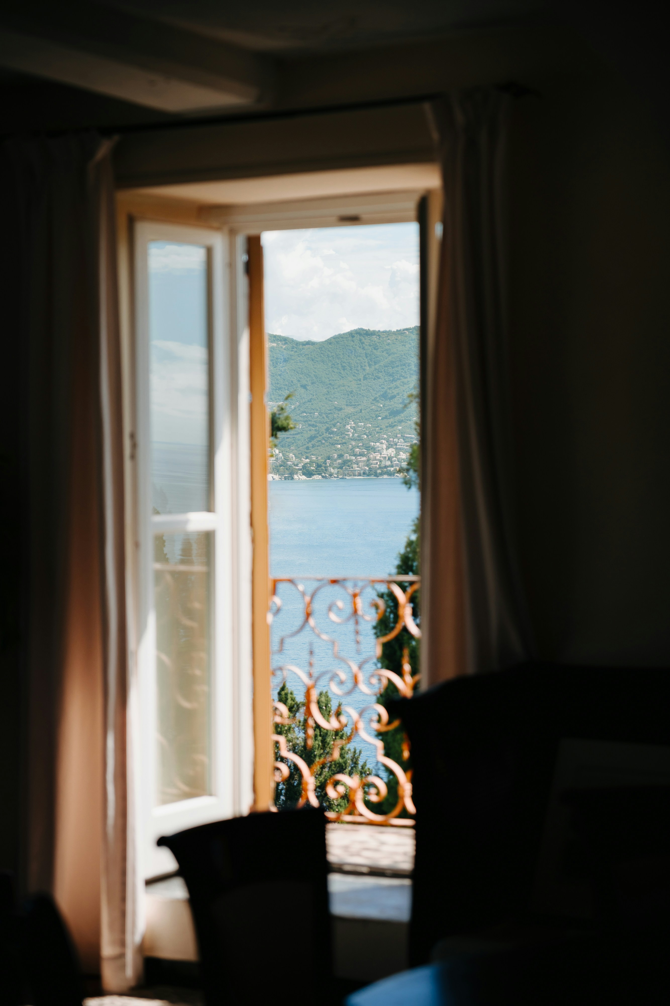 An open window with a view of a body of water