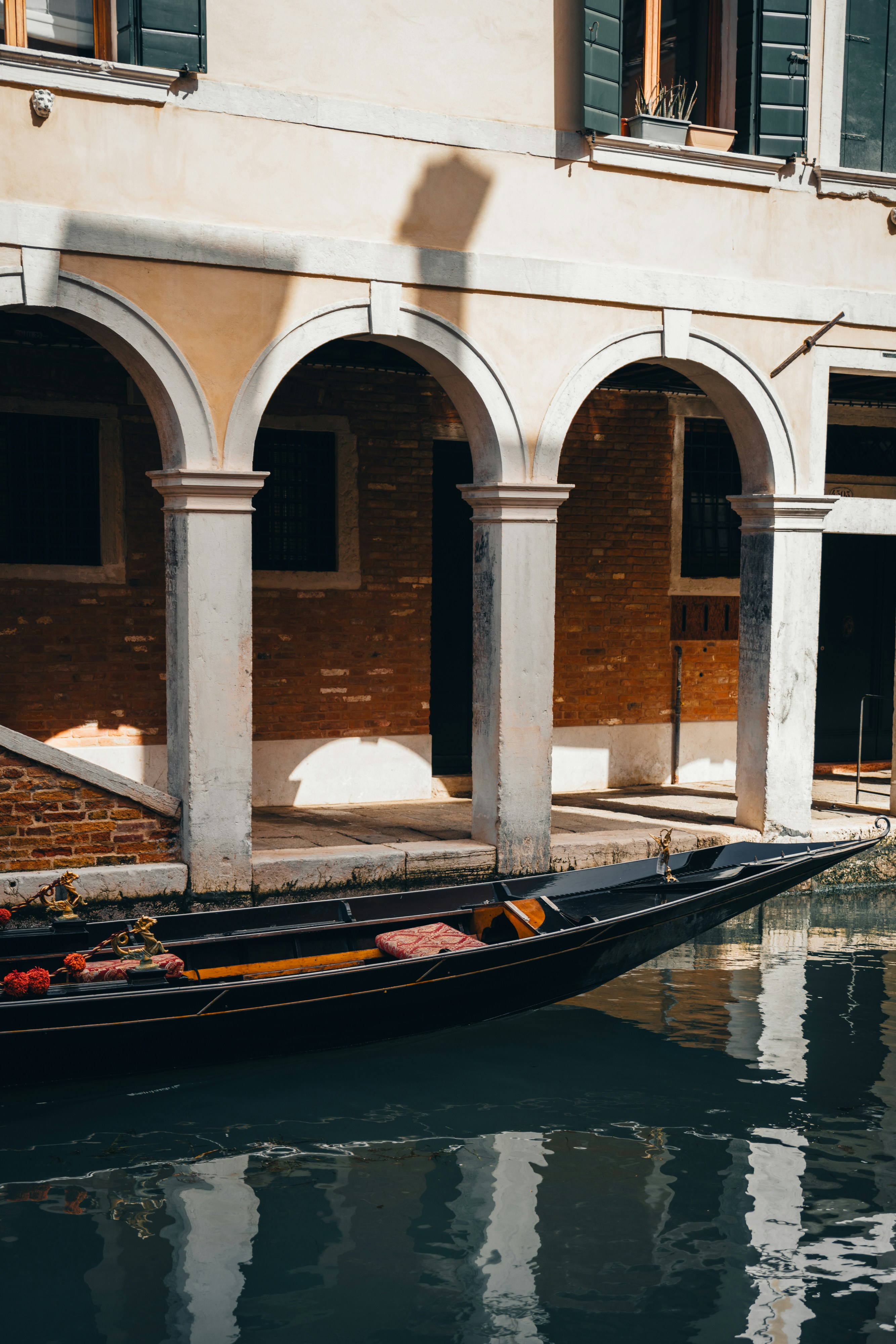 A gondola in a canal in front of a building