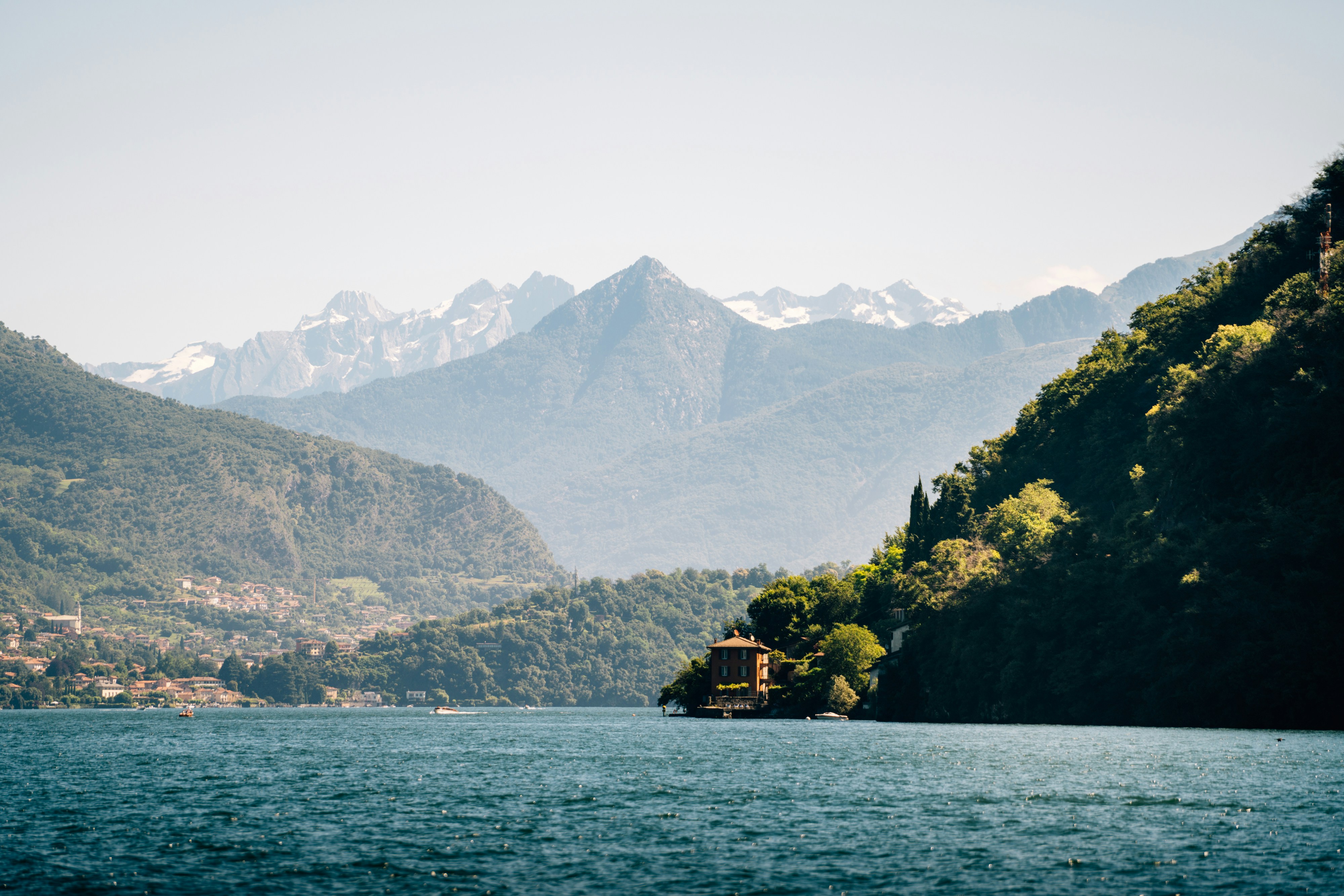A body of water with mountains in the background, 