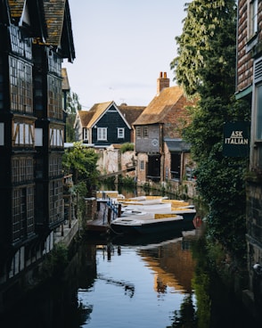 A boat is docked in a narrow canal