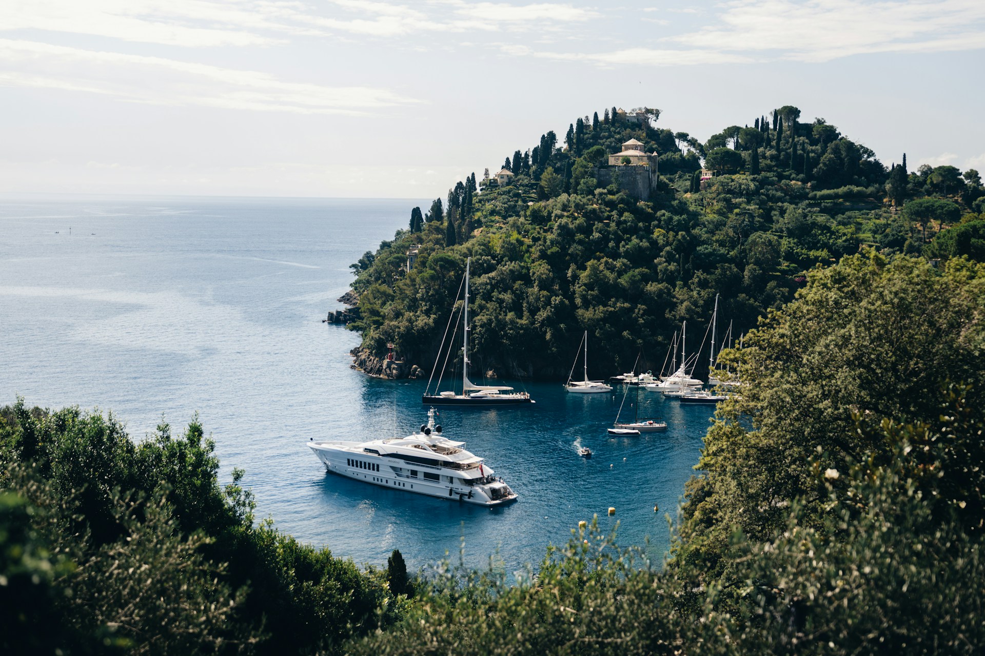 A group of boats floating on top of a body of water