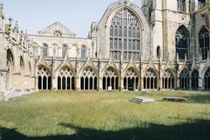 A large building with many windows and grass