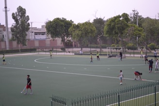 A group of people standing on top of a tennis court