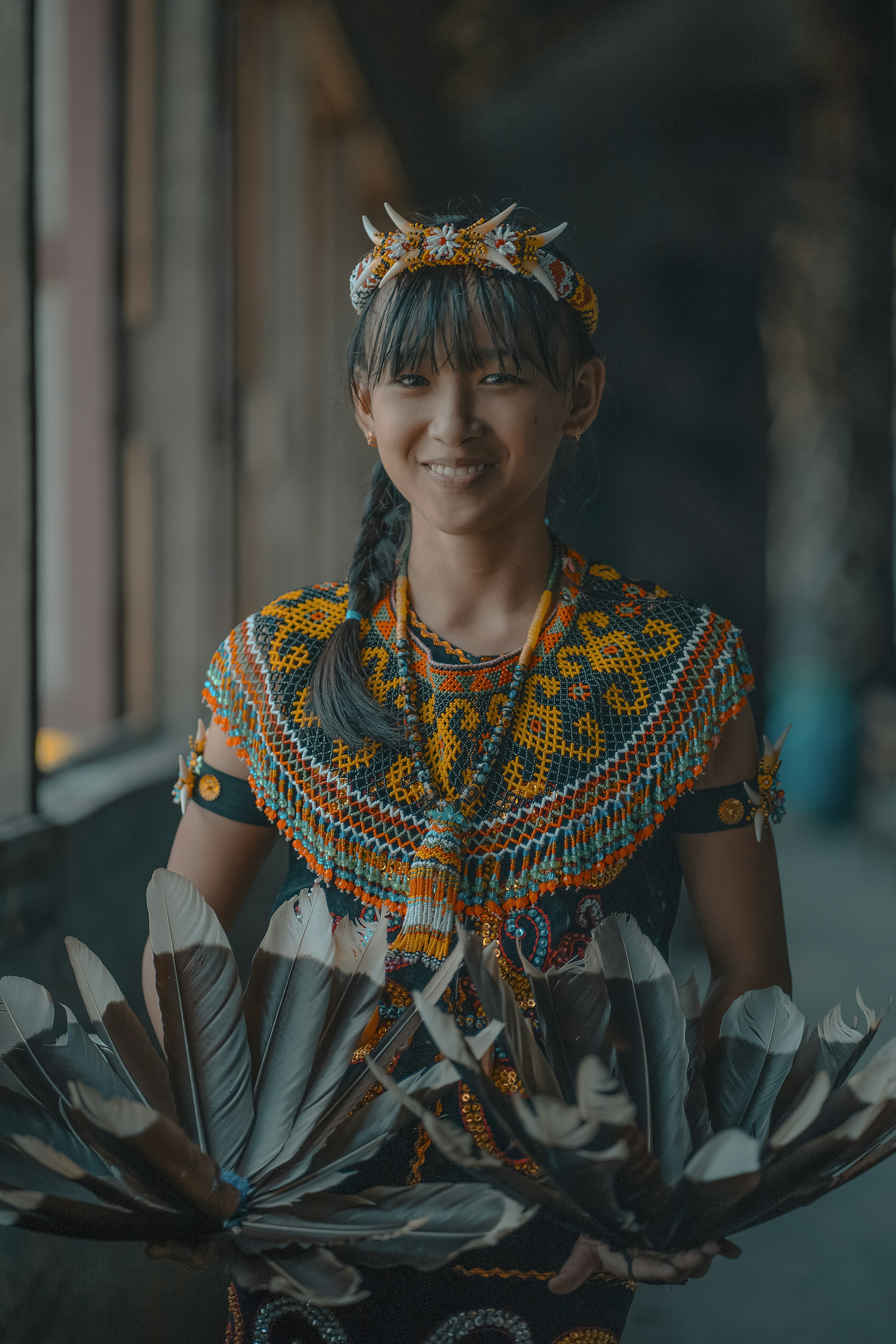 A woman in a colorful dress holding a fan
