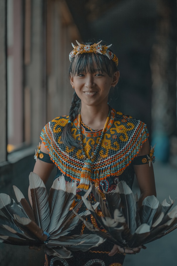 A woman in a colorful dress holding a fan