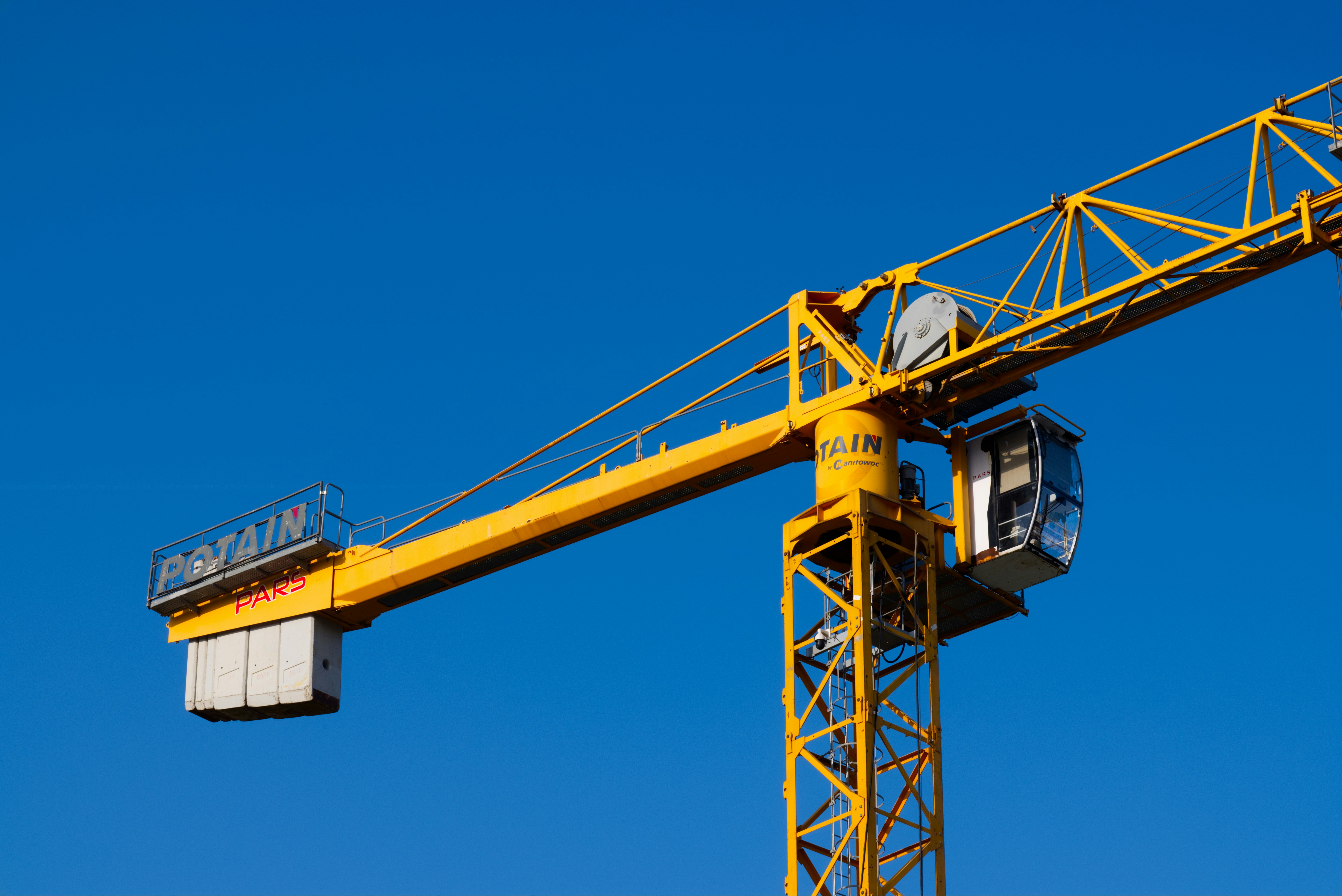 A yellow crane with a blue sky in the background