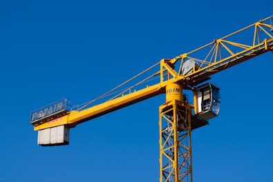A yellow crane with a blue sky in the background