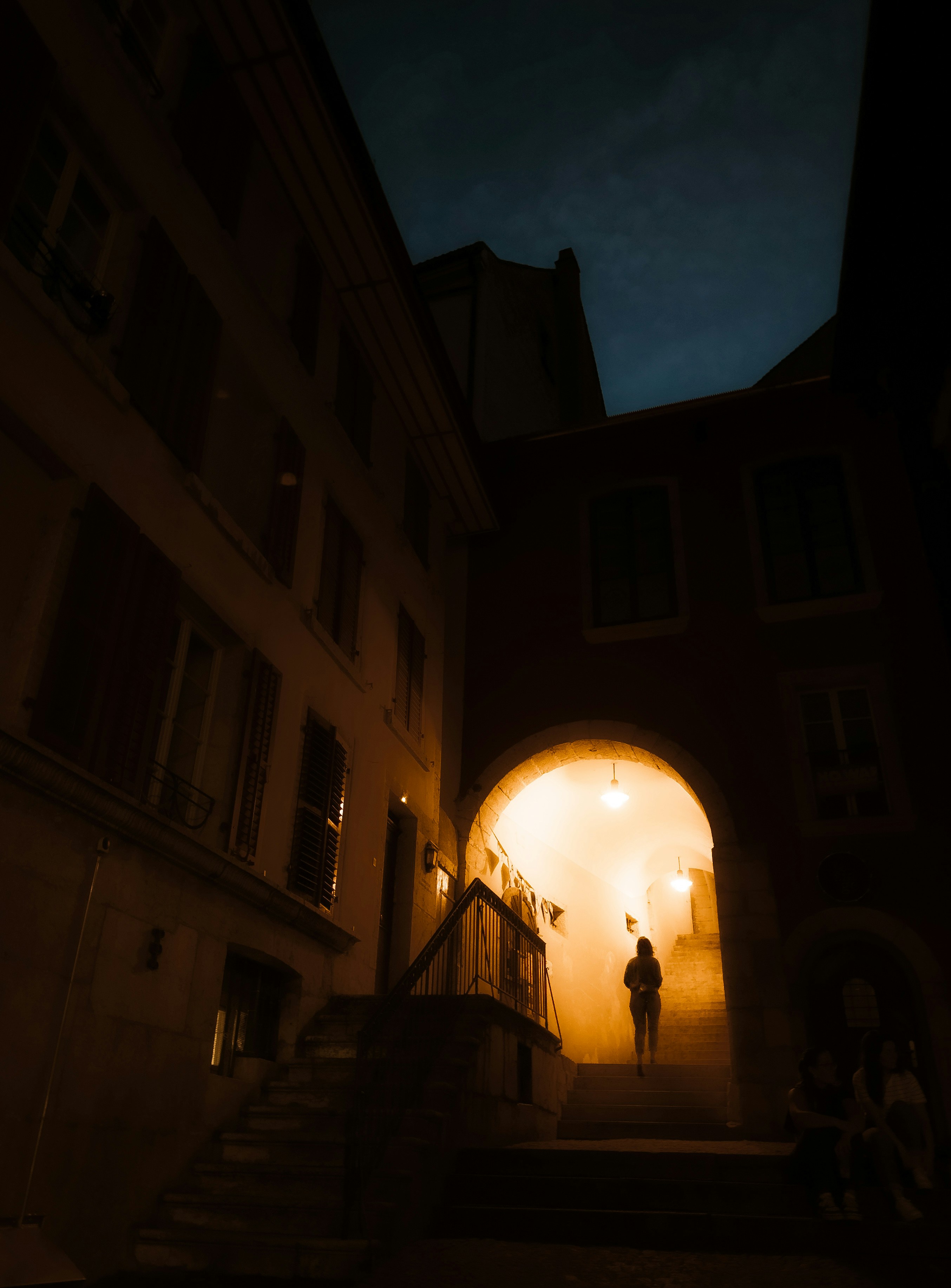 A person walking down a dark alley way