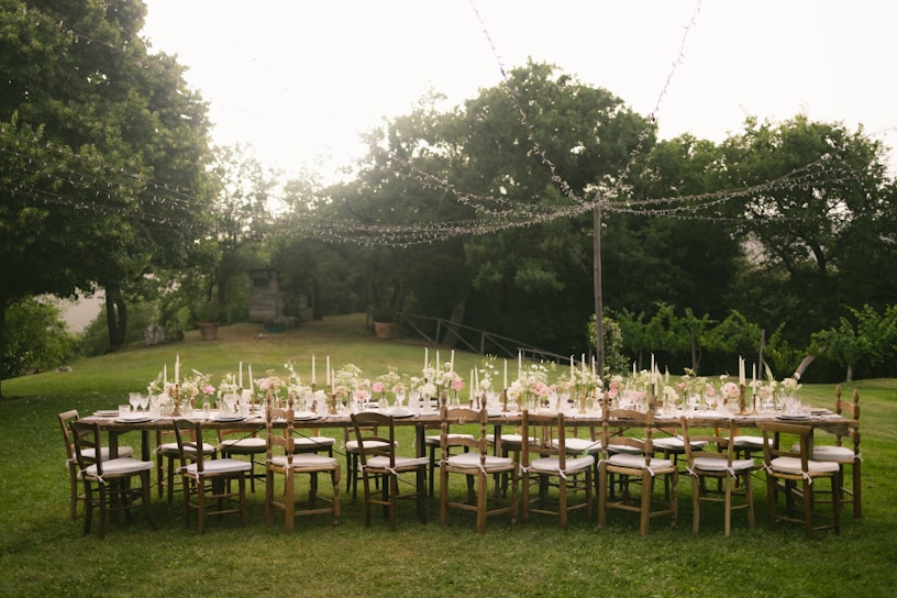 A long table set up in the middle of a field