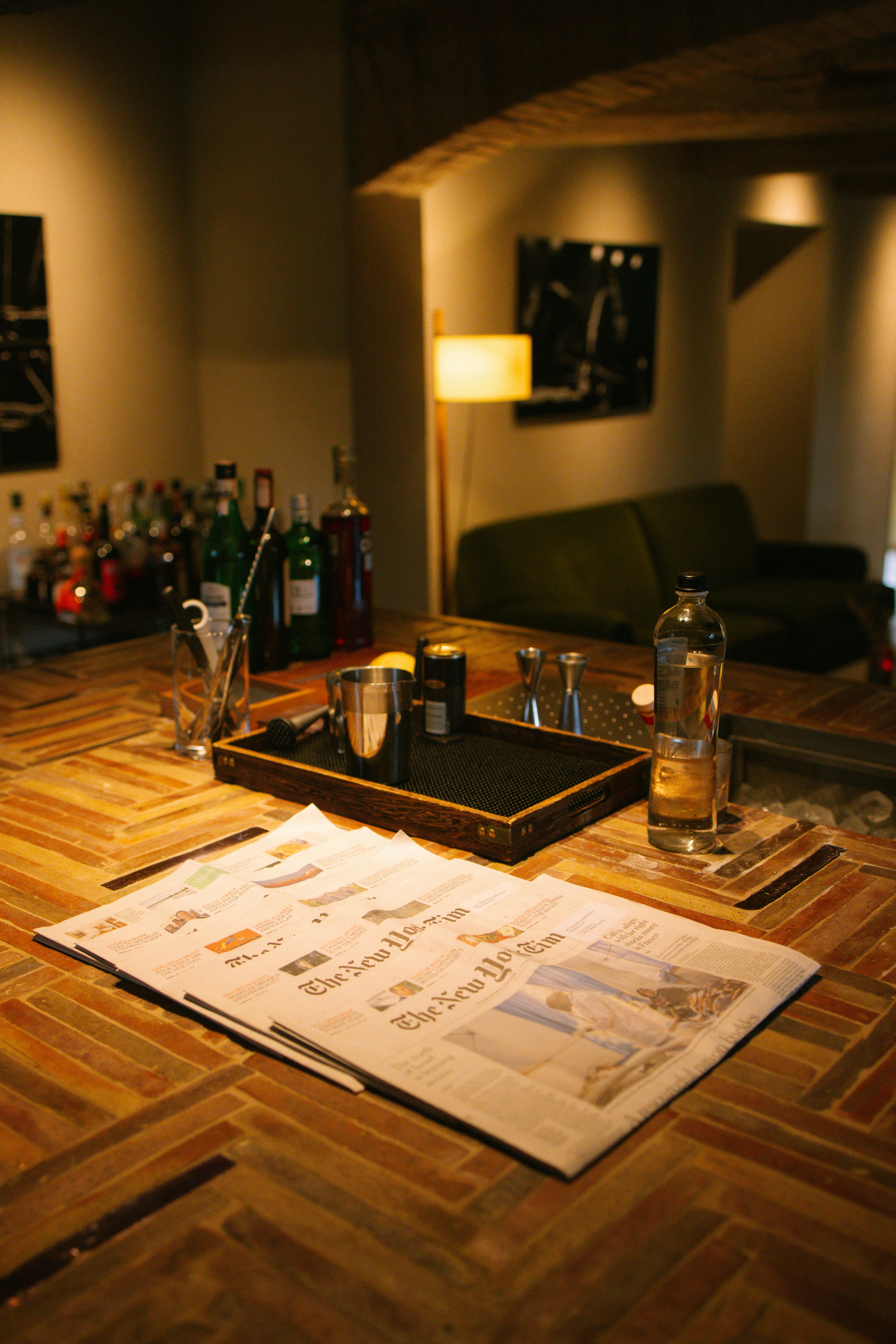 A bar with a lot of bottles and glasses on it