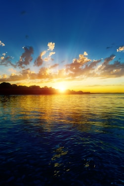 The sun is setting over a body of water