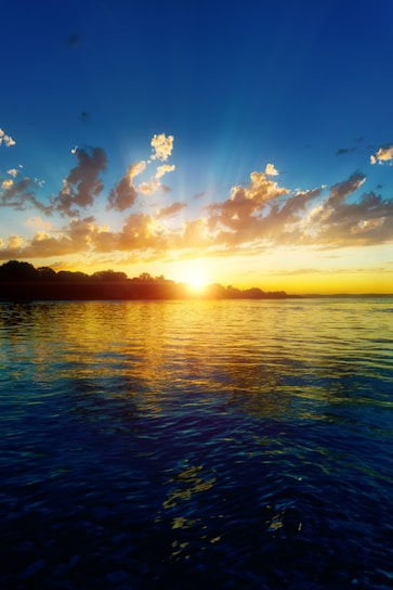 The sun is setting over a body of water