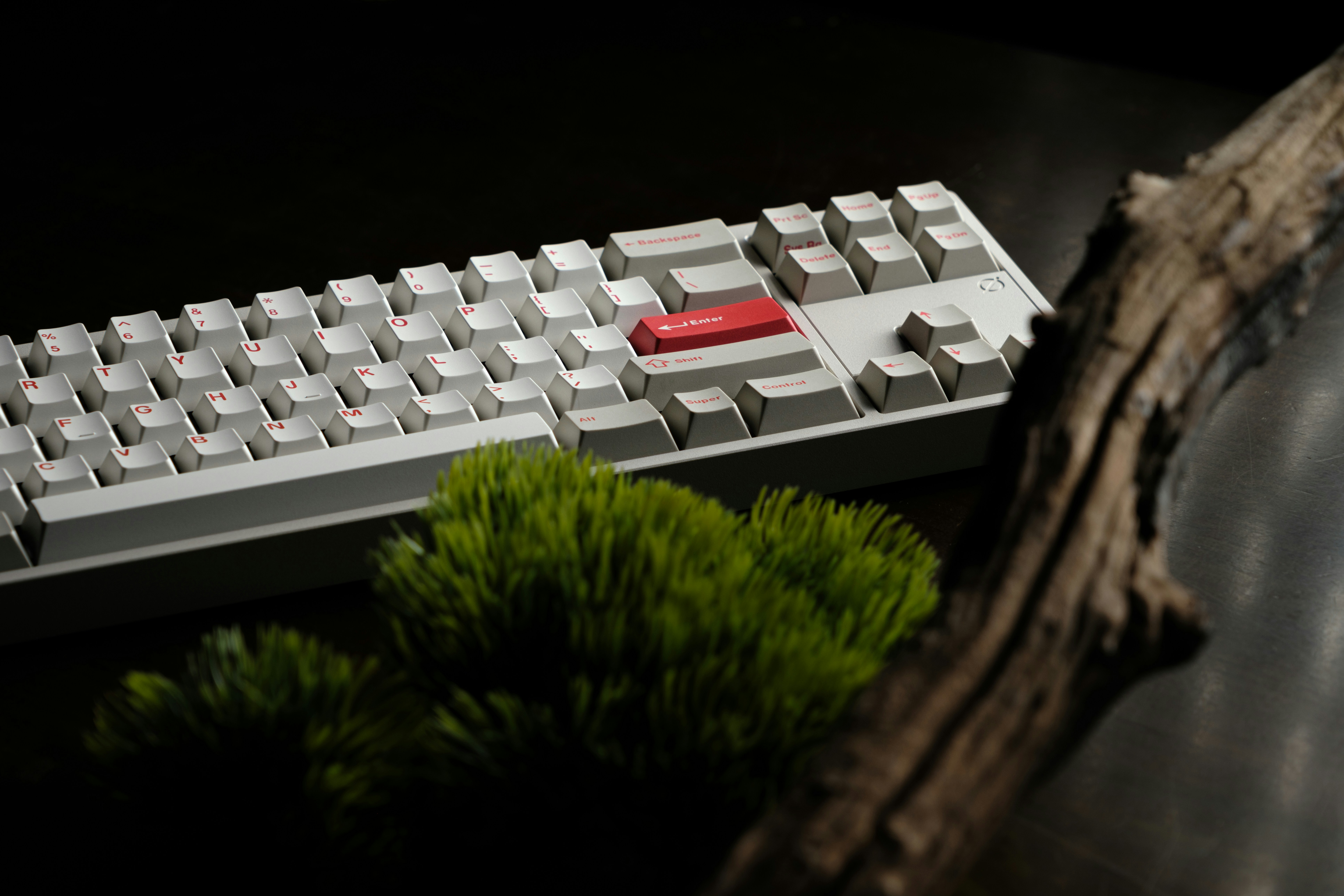 A computer keyboard sitting on top of a wooden table