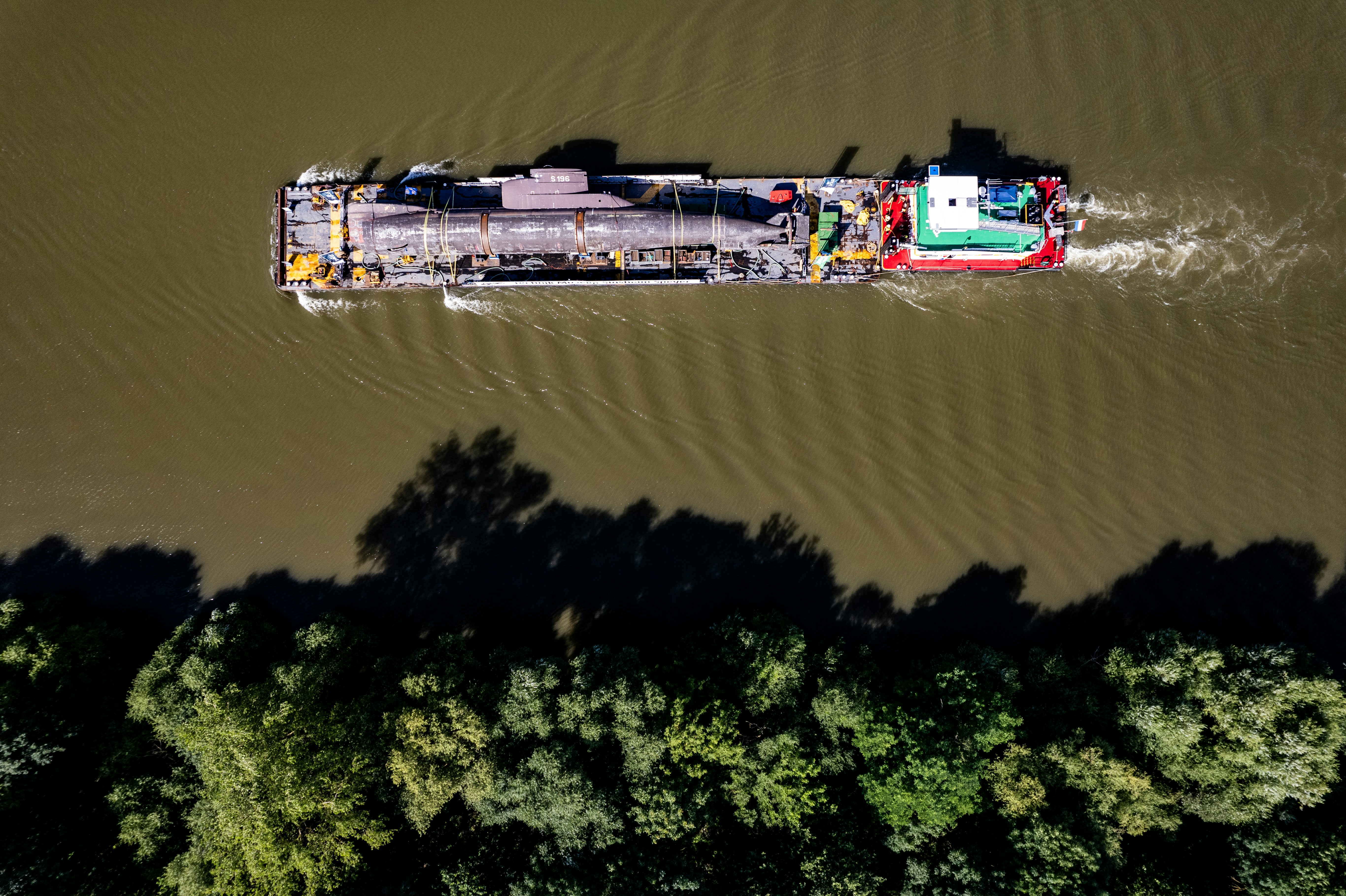 A large boat floating on top of a river