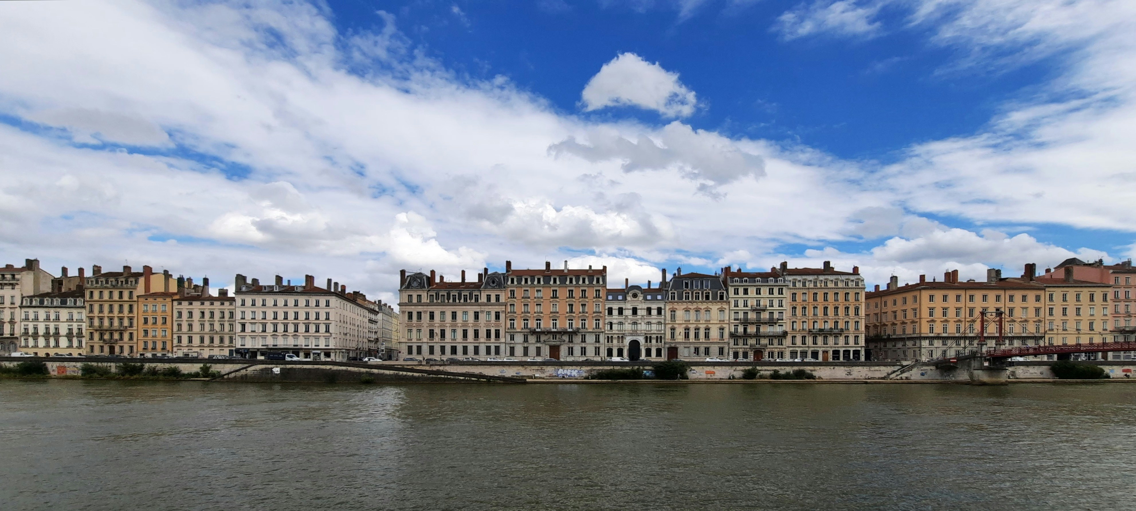 A view of a city across a body of water, Buildings on the side of the river at daytime