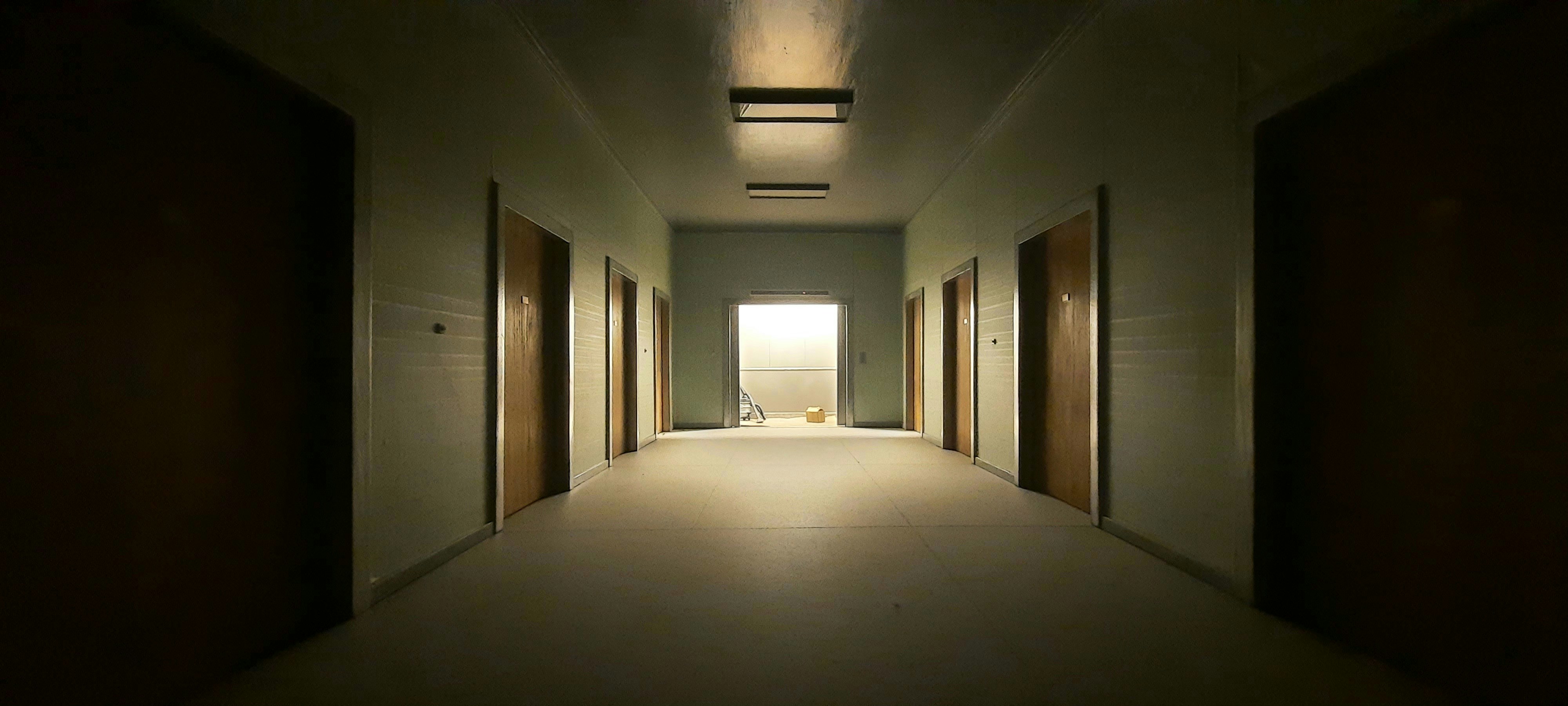 A long hallway with a light at the end