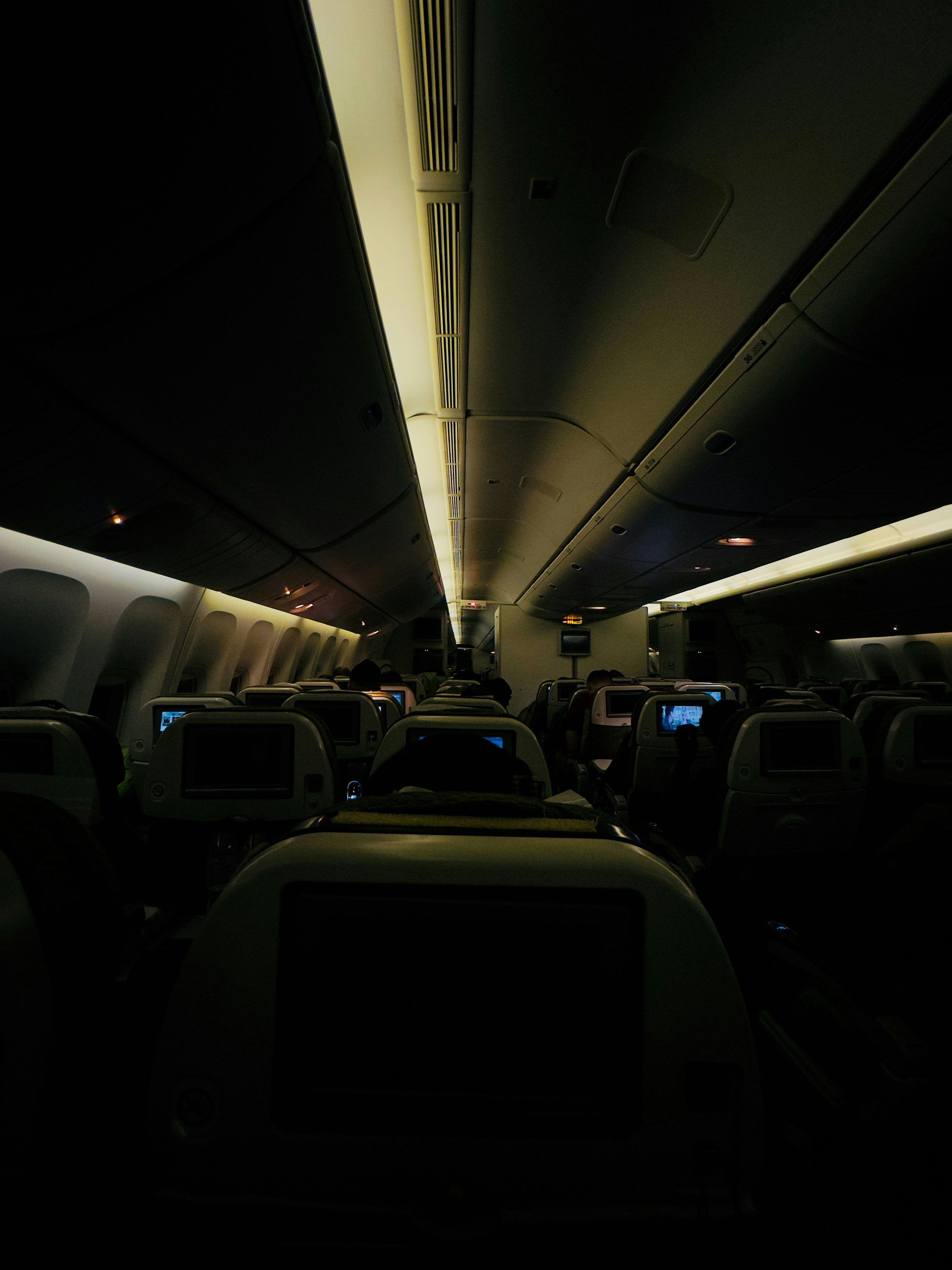 The inside of an airplane with the lights on