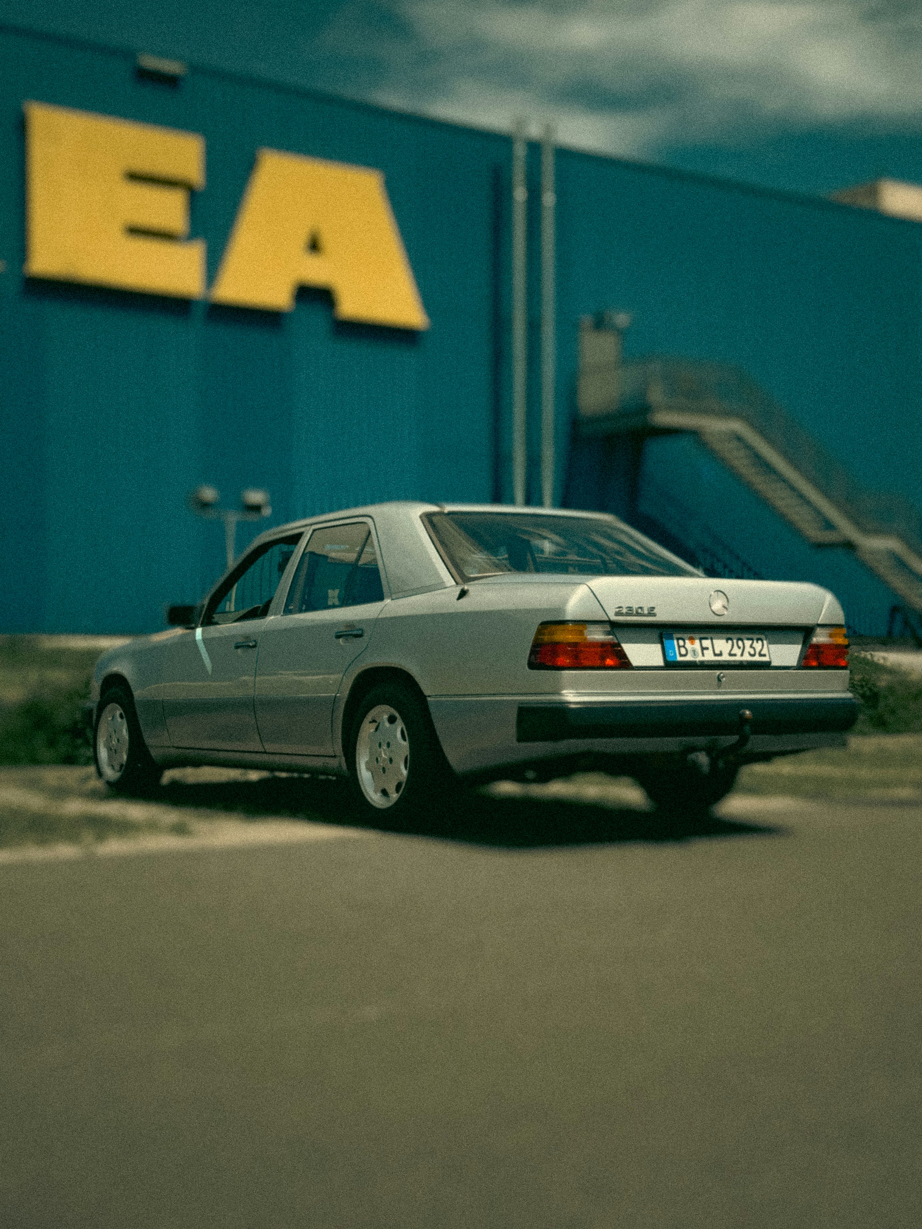 A silver car parked in front of a building