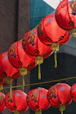 A bunch of red lanterns hanging from a line