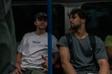 A group of men sitting on a bus next to each other