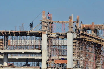 A large building under construction with a sky background