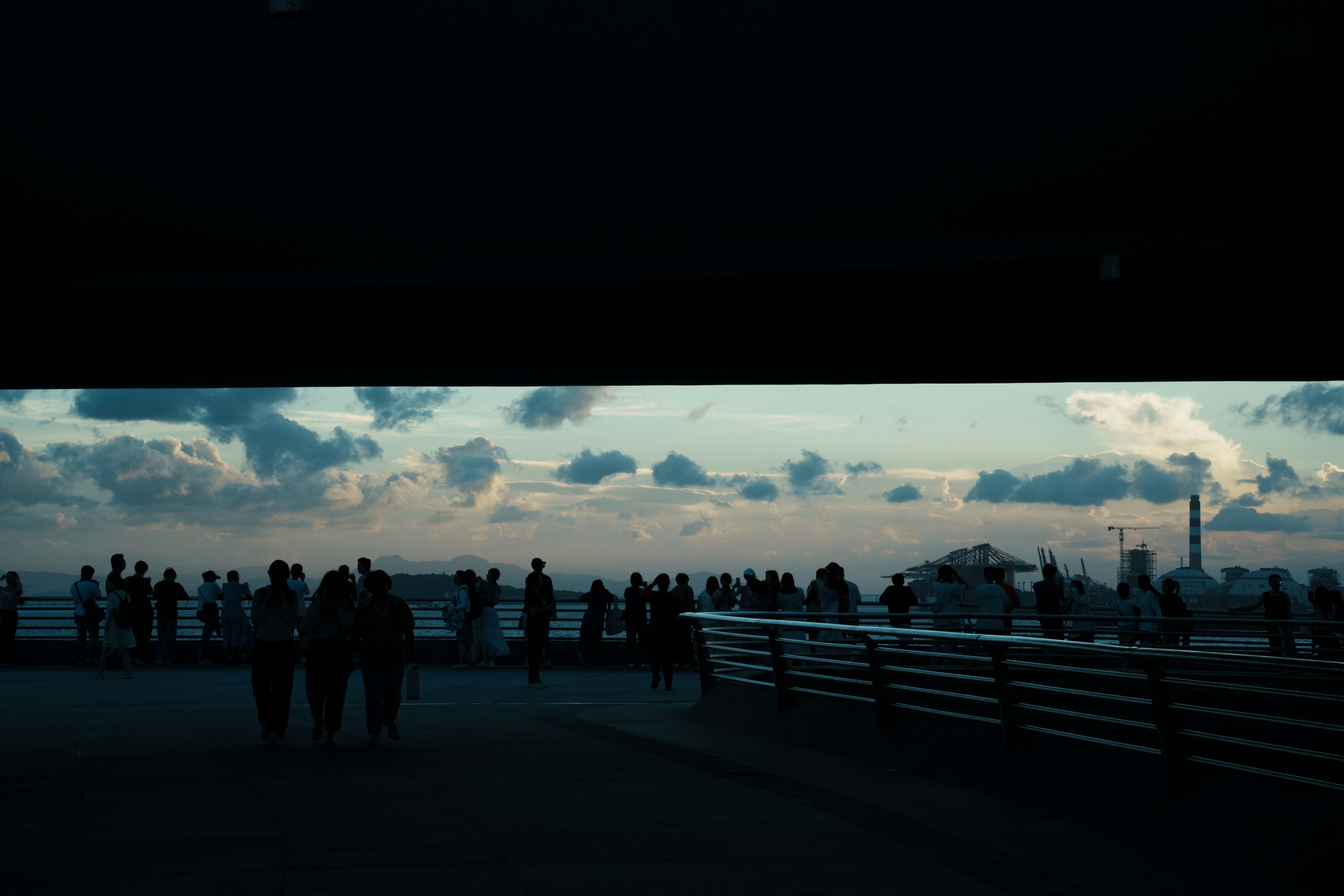 A group of people standing on top of a pier
