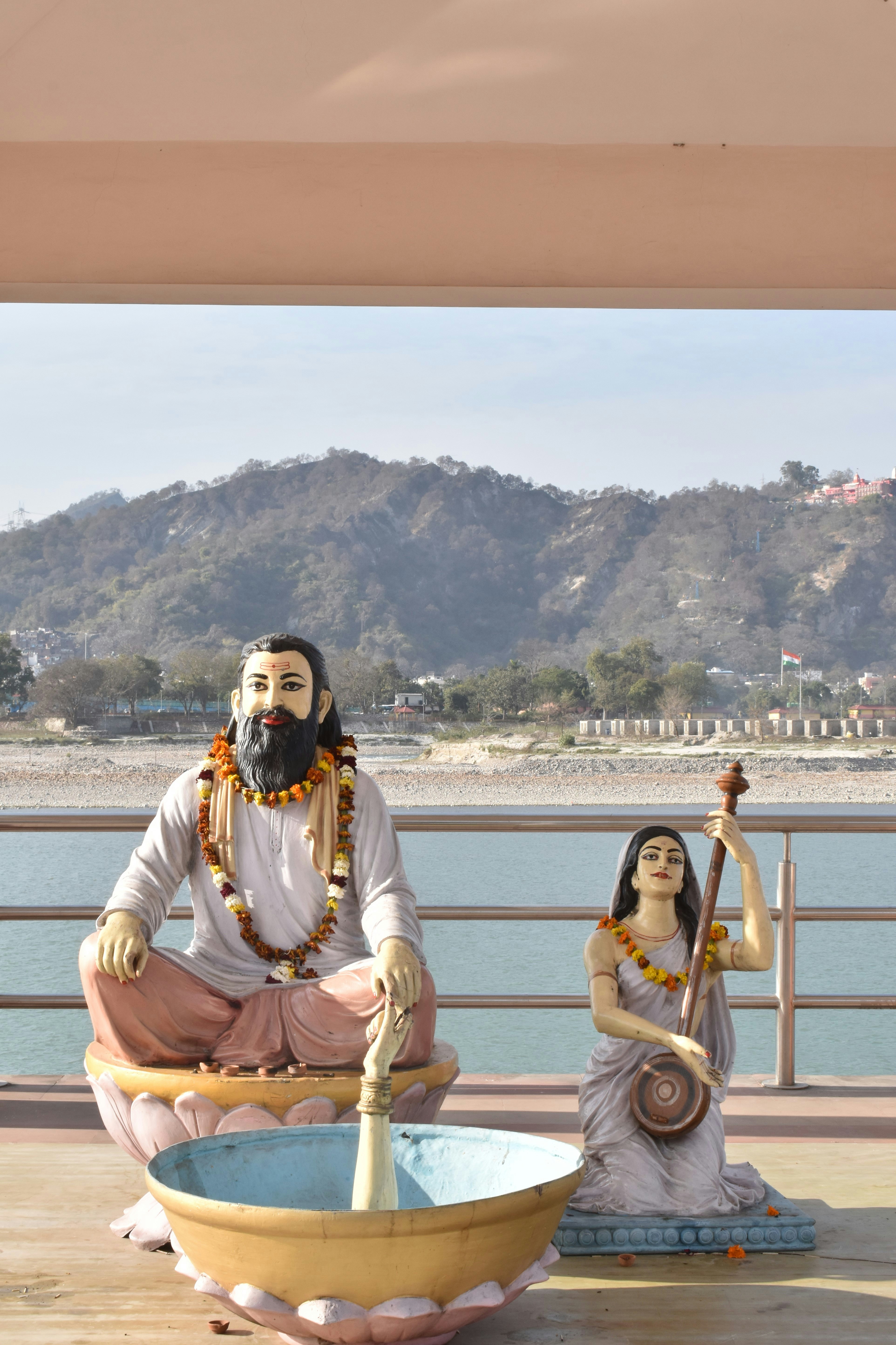 A statue of a man and a woman sitting on a boat