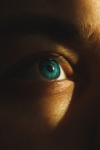 A close up of a person's face with a blue eye